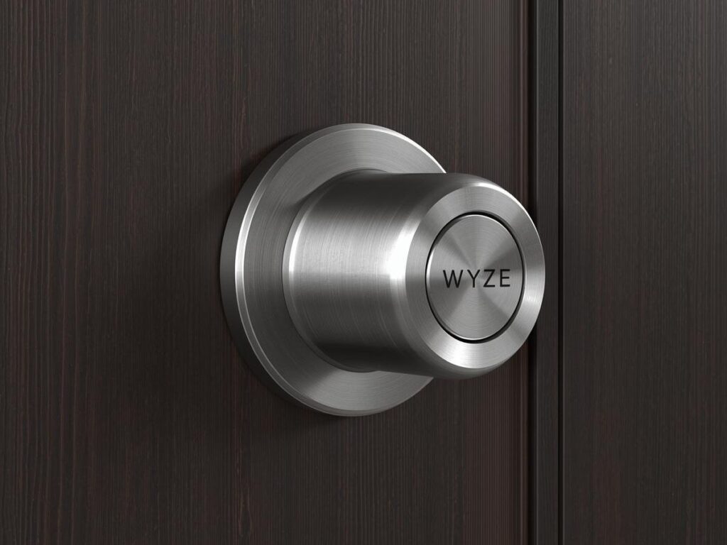 Sleek smart deadbolt installed on a dark wood front door