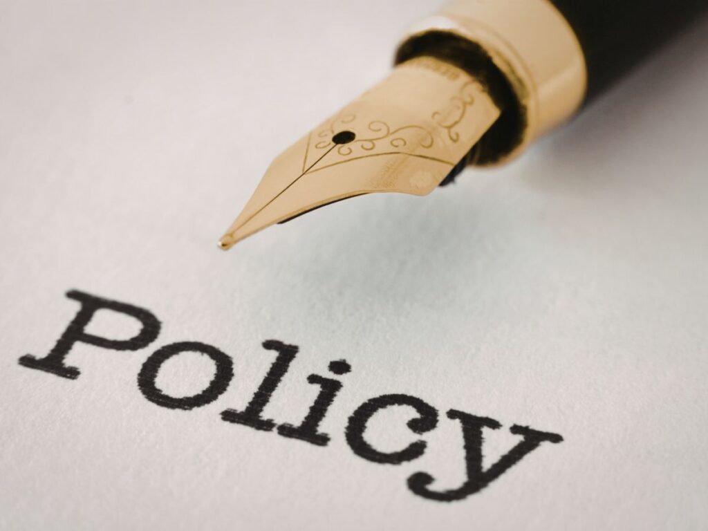 Fountain pen beside printed policy text on a document page