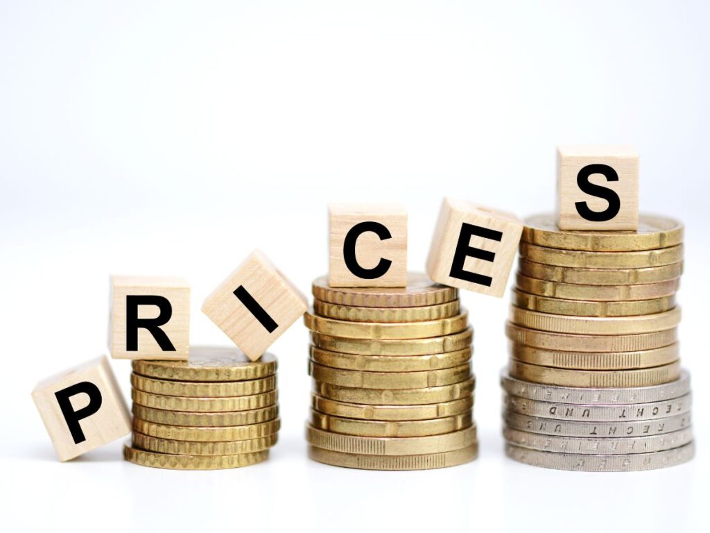 Coins stacked with letter blocks spelling PRICE