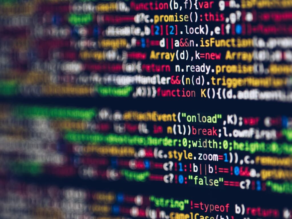 Close-up of colorful computer code on a blurred screen